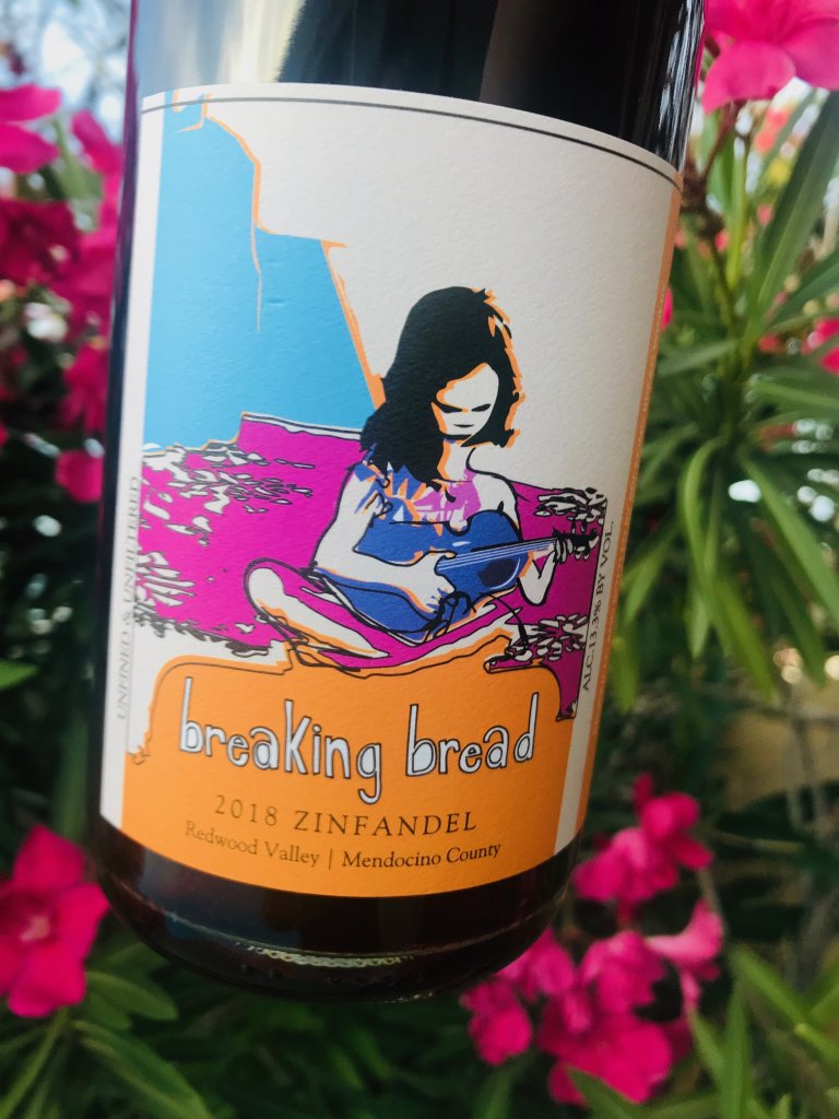 Breaking Bread bottle of wine. The label has a girl with dark hair holding a small guitar